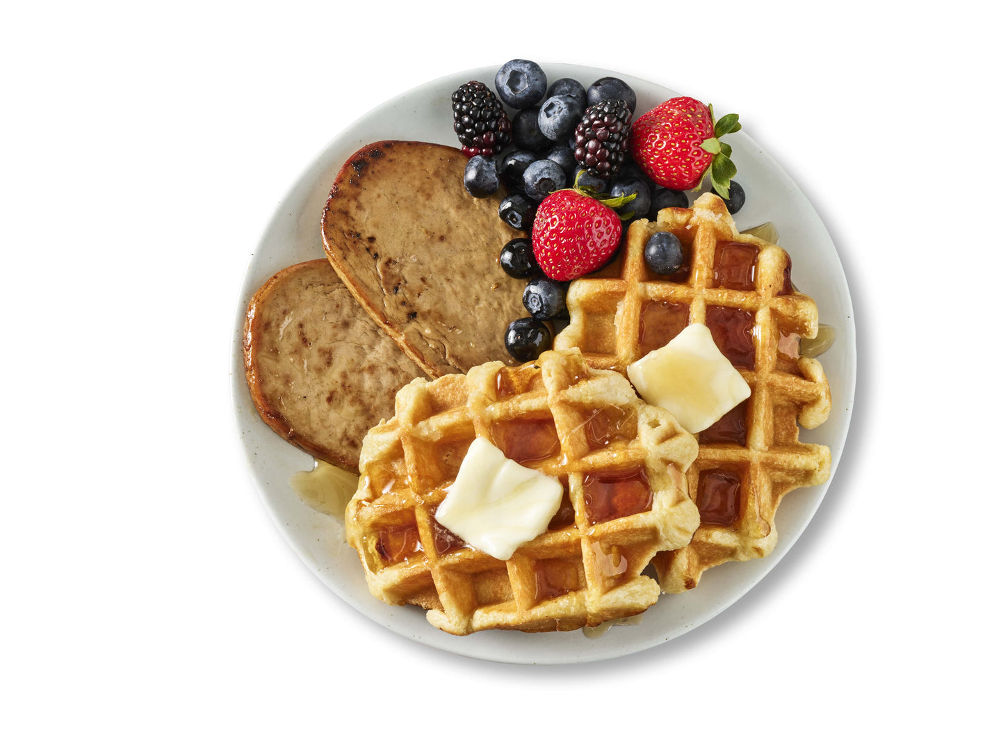 Meati breakfast patty on a plate with waffles.